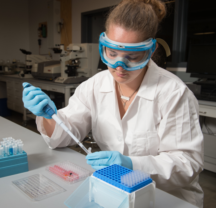 student researcher transferring liquids